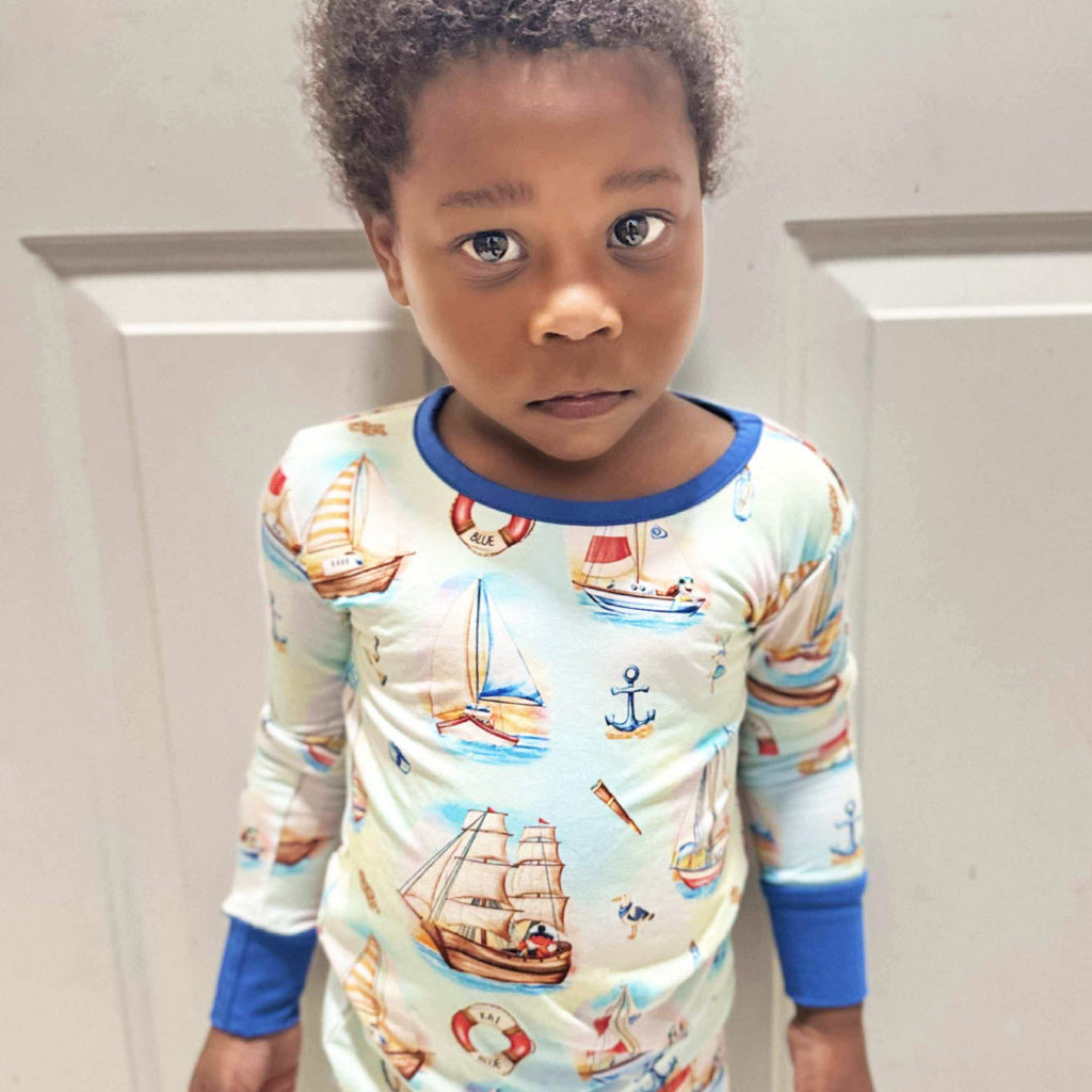 Child wearing bamboo pajamas with sailing-inspired print by Kai Blue™