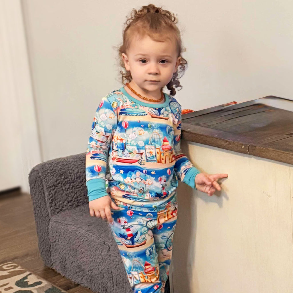 Child standing while wearing bamboo pajamas with an underwater carnival print
