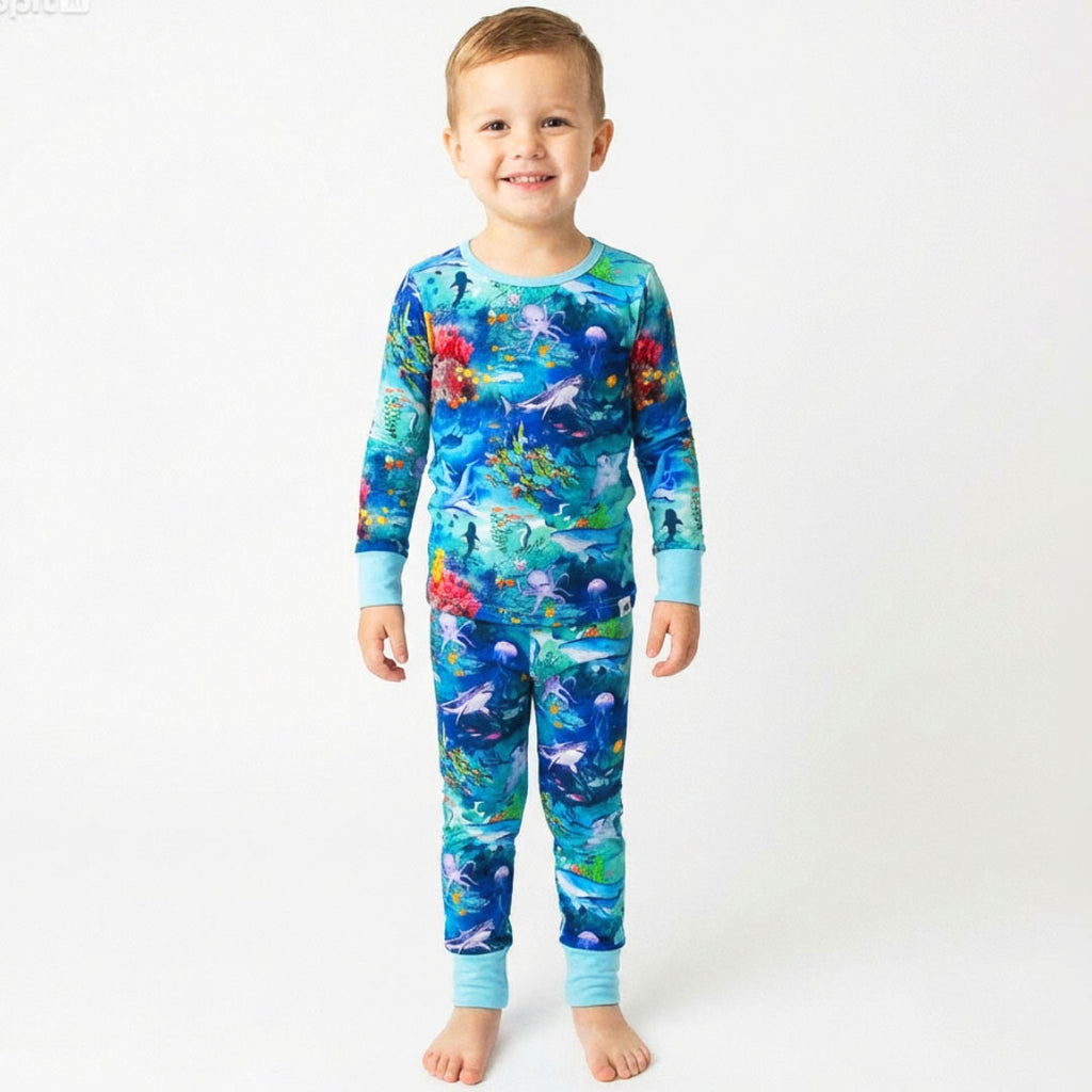 Child in bamboo pajamas wearing Open Ocean 2.0 Kai Blue Bamboo