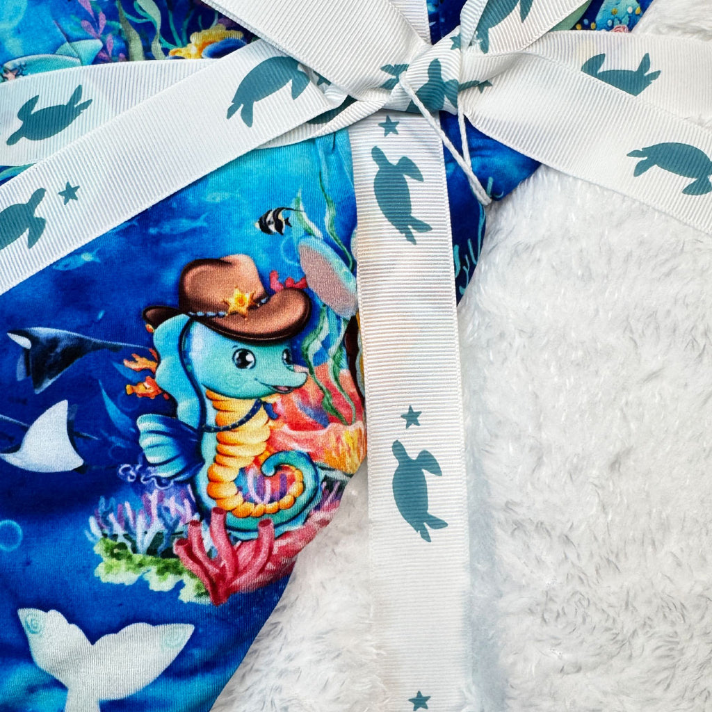 Bamboo Blanket with white plush backing in underwater sea print -close-up view - Kai Blue