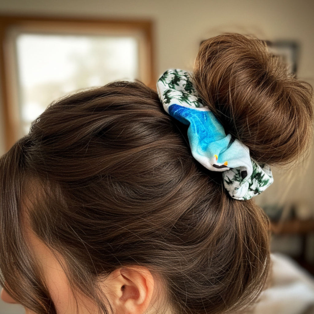 Close-up of a person's hair with a blue scrunchie, blurred indoor background