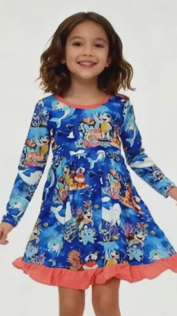 Girl dancing in ocean-themed bamboo dress by Kai Blue