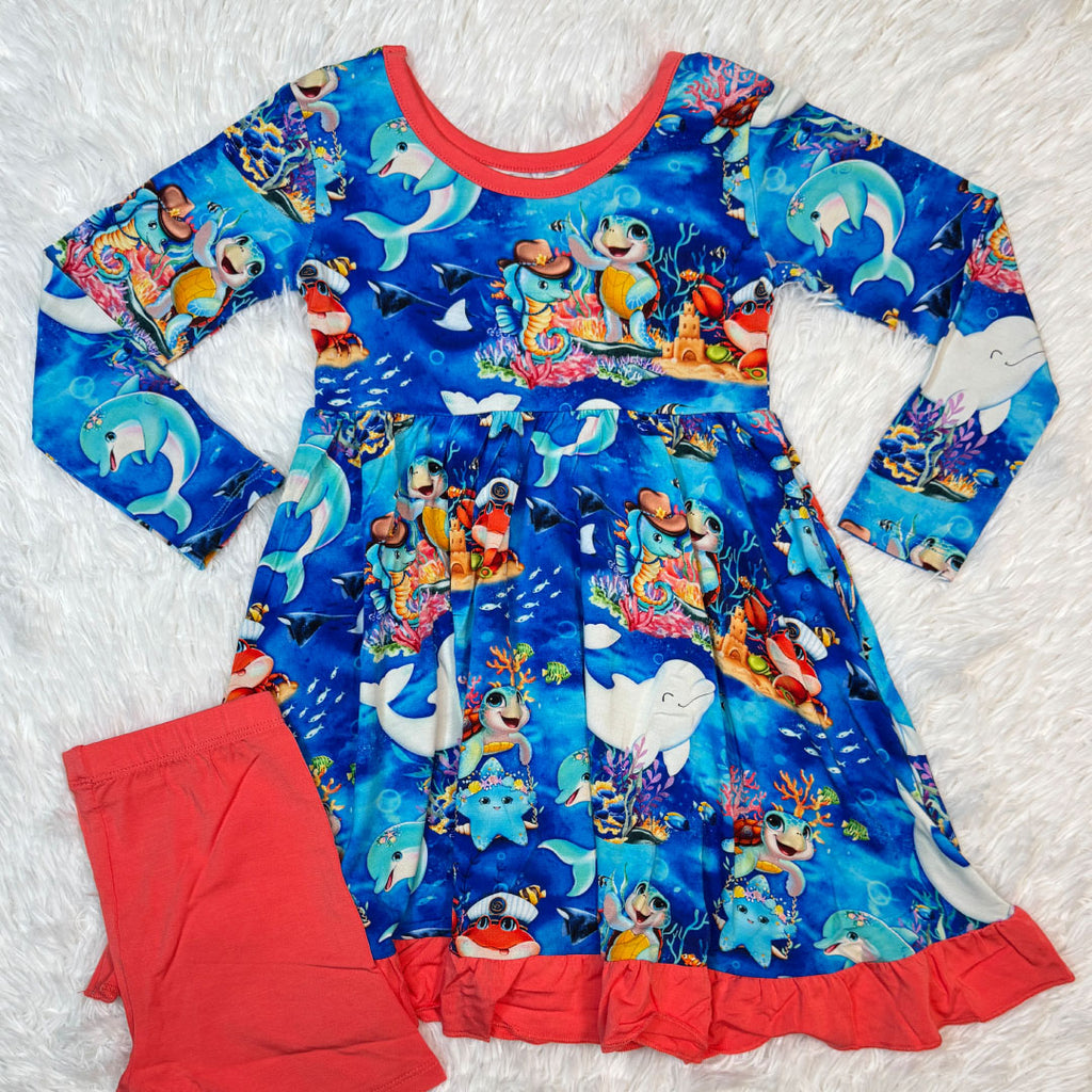 Flat lay of children's bamboo dress with character ocean-themed print by Kai Blue™