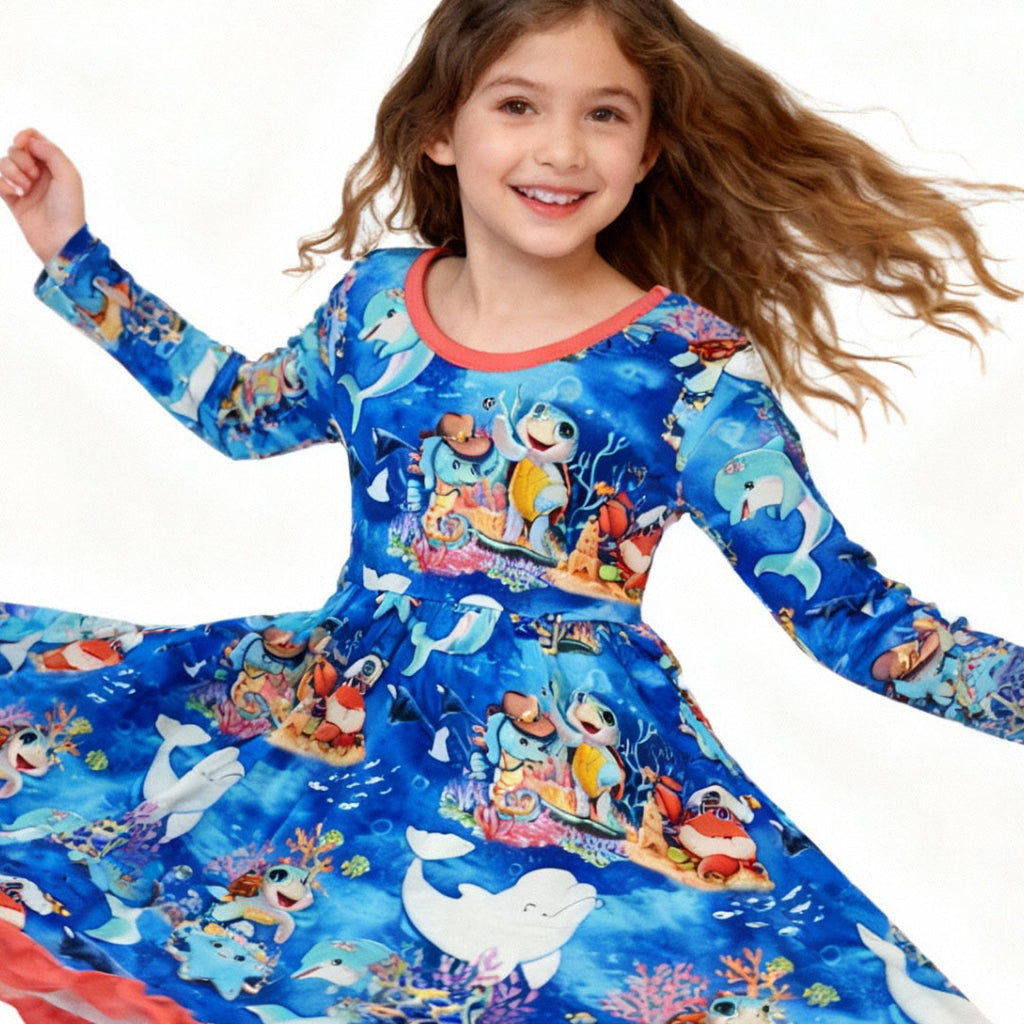 Young girl wearing an ocean-themed bamboo dress with character print by Kai Blue
