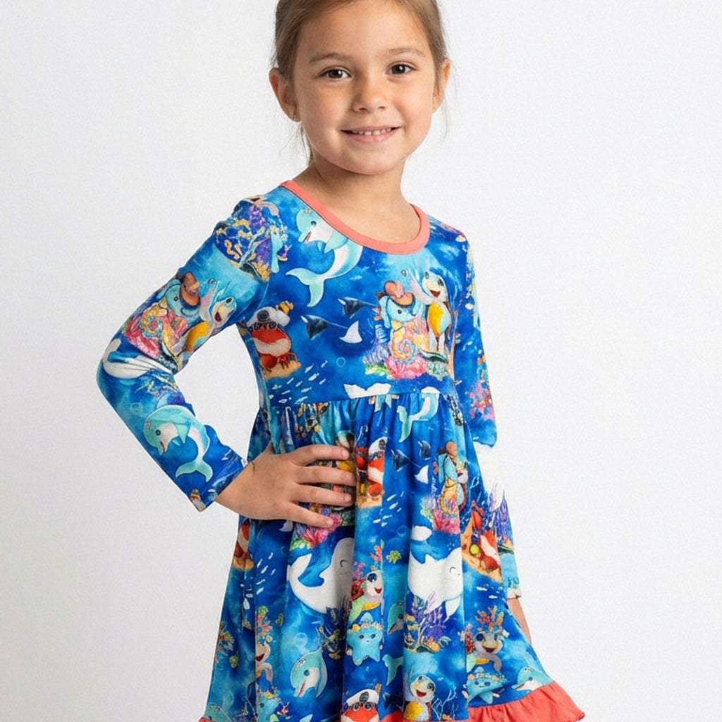 Young girl wearing a bamboo dress with an ocean-themed kai blue print