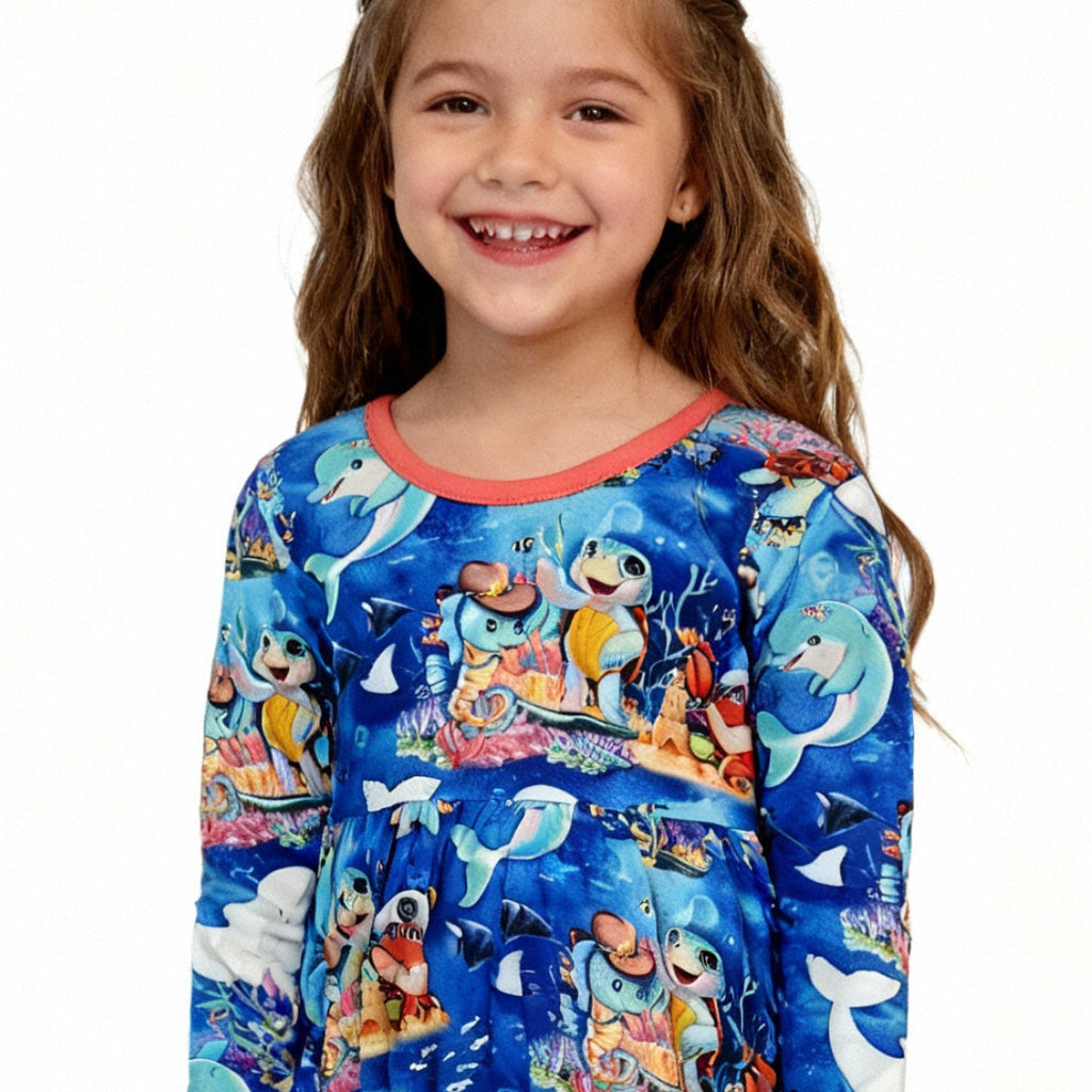 Front view of a girl wearing ocean-themed bamboo dress by Kai blue™