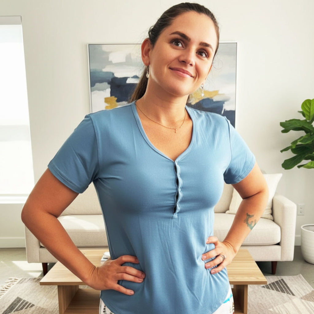 Woman wearing a frosty blue shirt in a living room setting